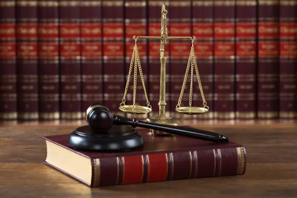 Stock photo of a book, scale, and a gavel.